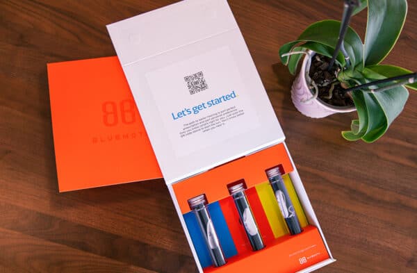 Open colorful hearing aid box with devices.