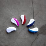 Colorful hearing aids next to each other.