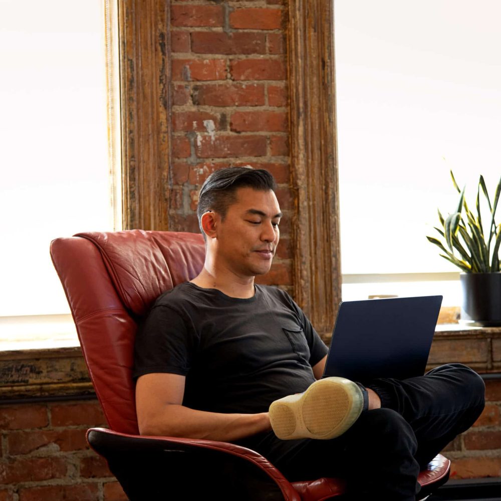 Man sitting peacefully looking at his computer.
