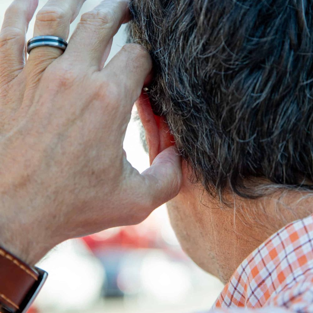man with hearing aide from behind